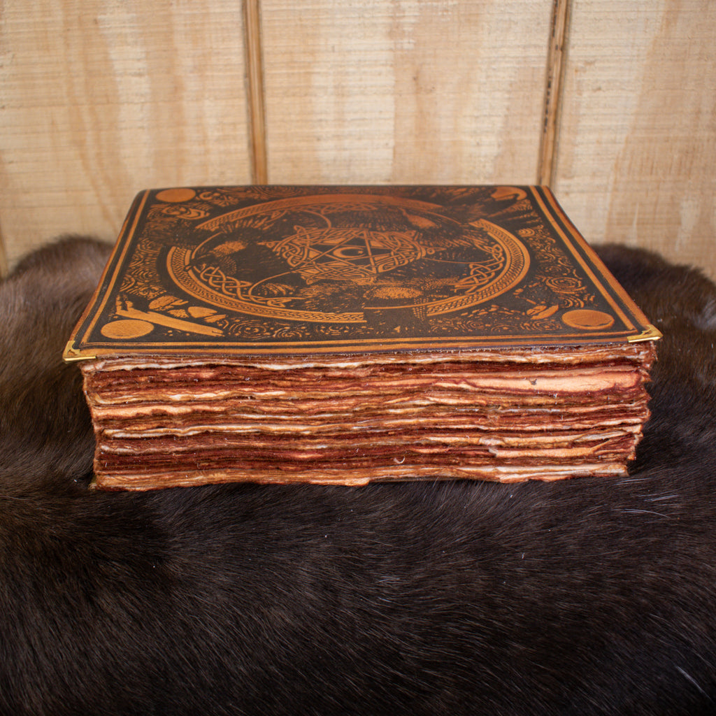 A large tan leather spell book journal featuring ravens and a pentacle