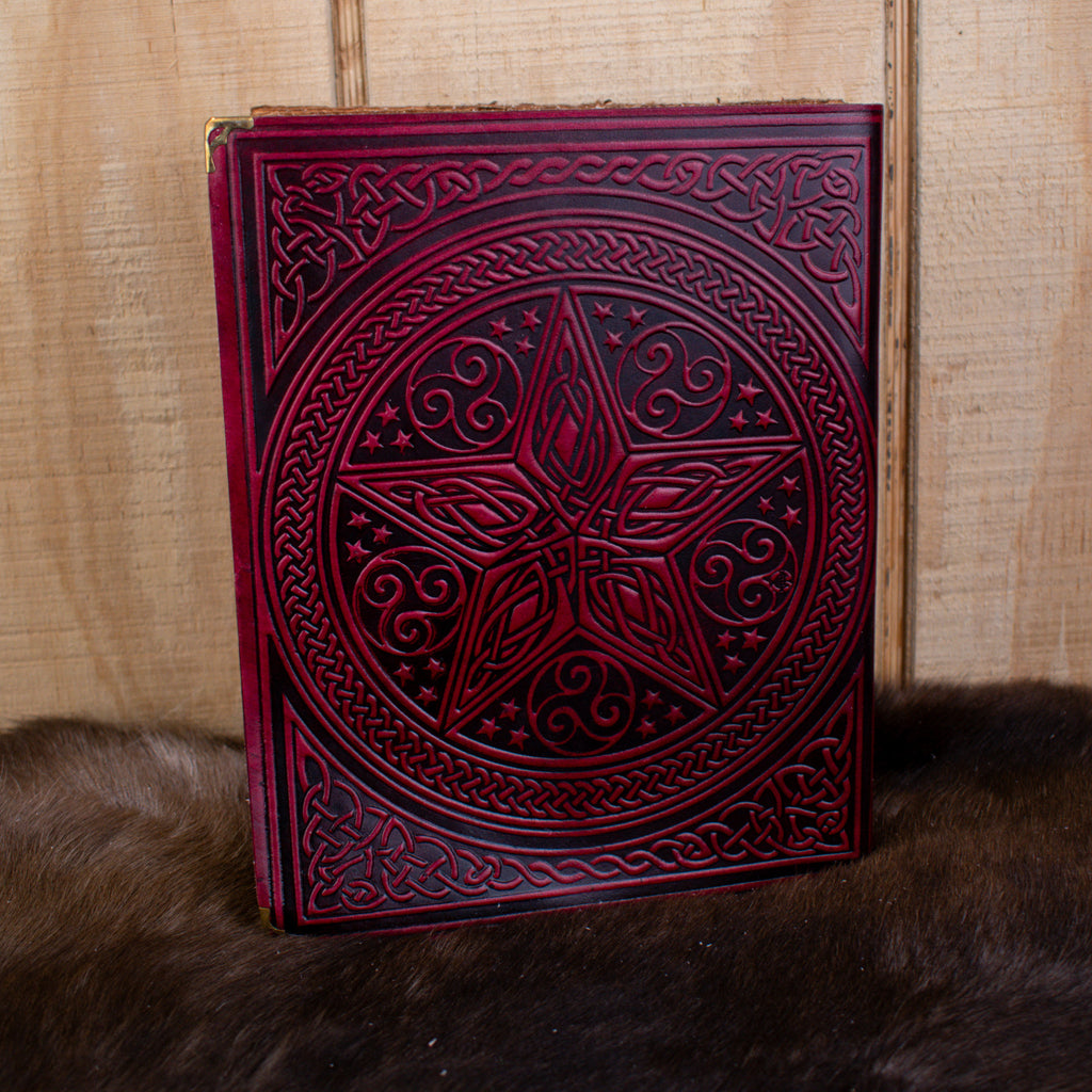 A large red spell book leather journal featuring a pentacle