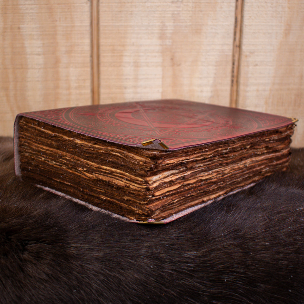 A large red spell book leather journal featuring a pentacle