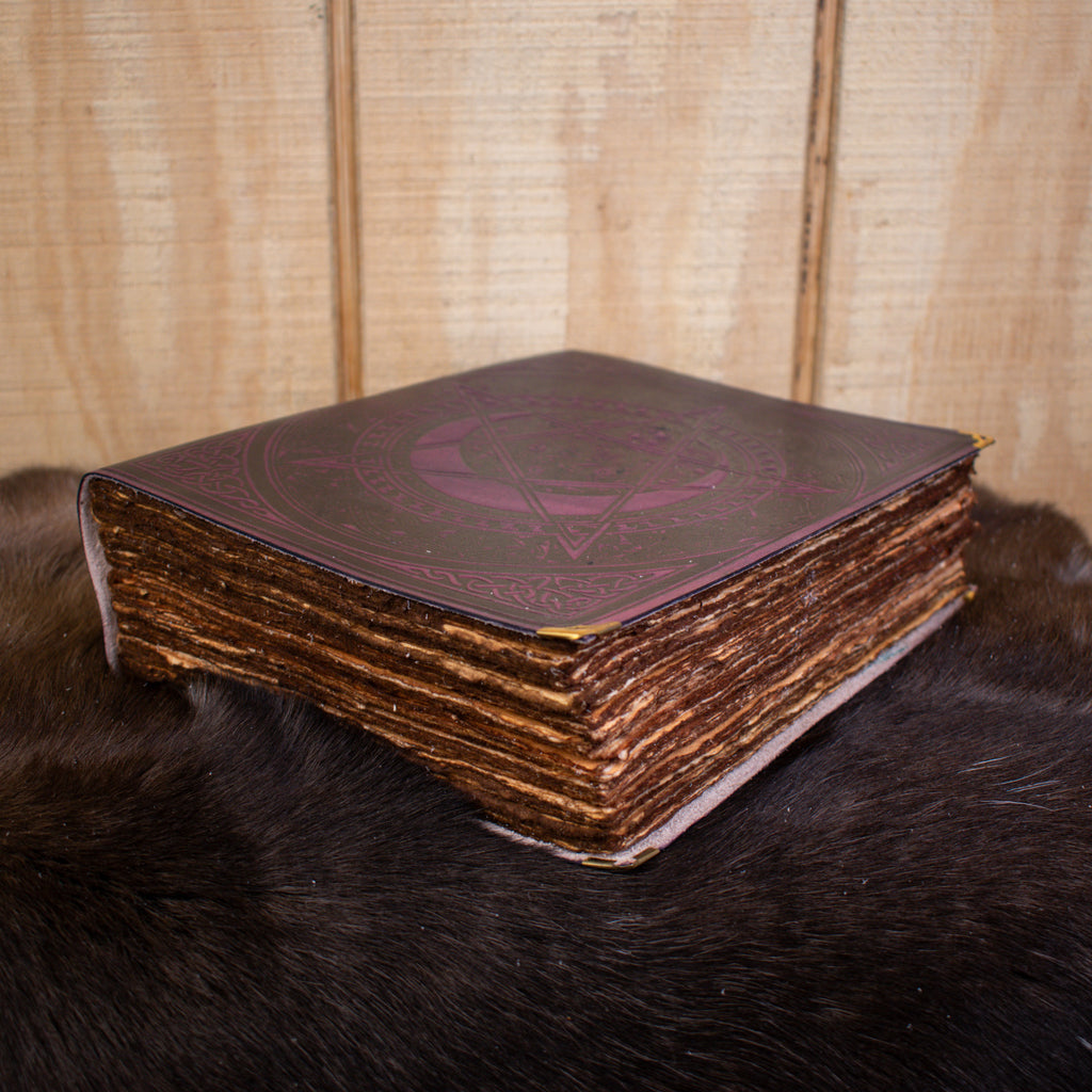 A large purple spell book leather journal featuring a pentacle