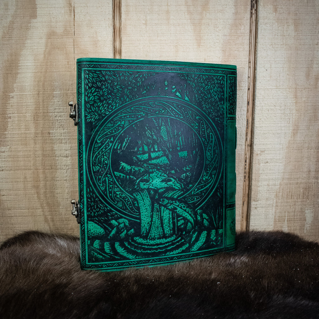 A green leather sketchbook featuring the tree of life