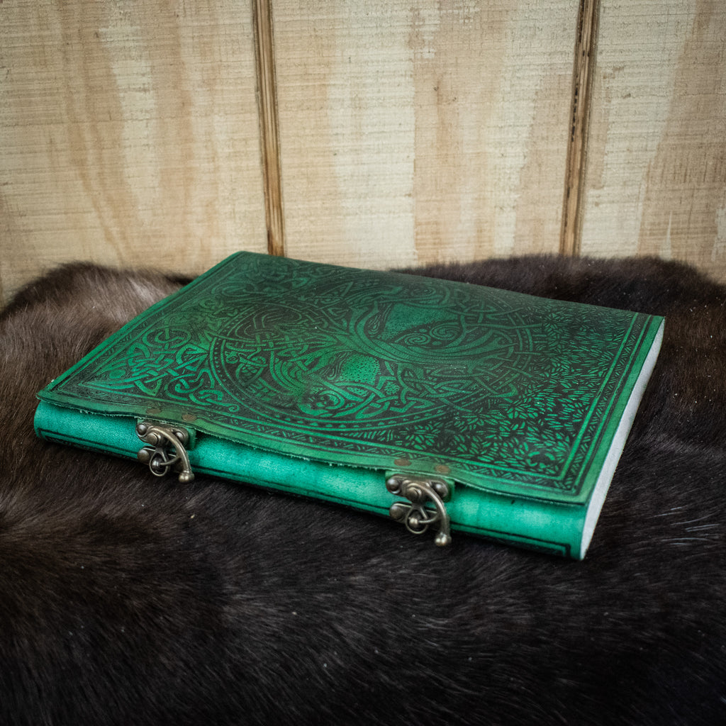 A green leather sketchbook featuring the tree of life