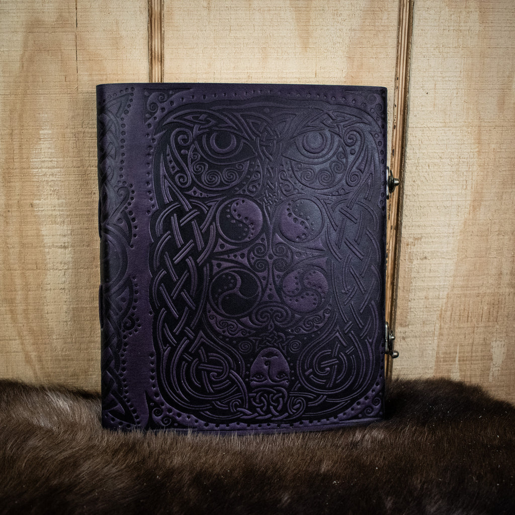 A leather sketchbook featuring an owl and woman
