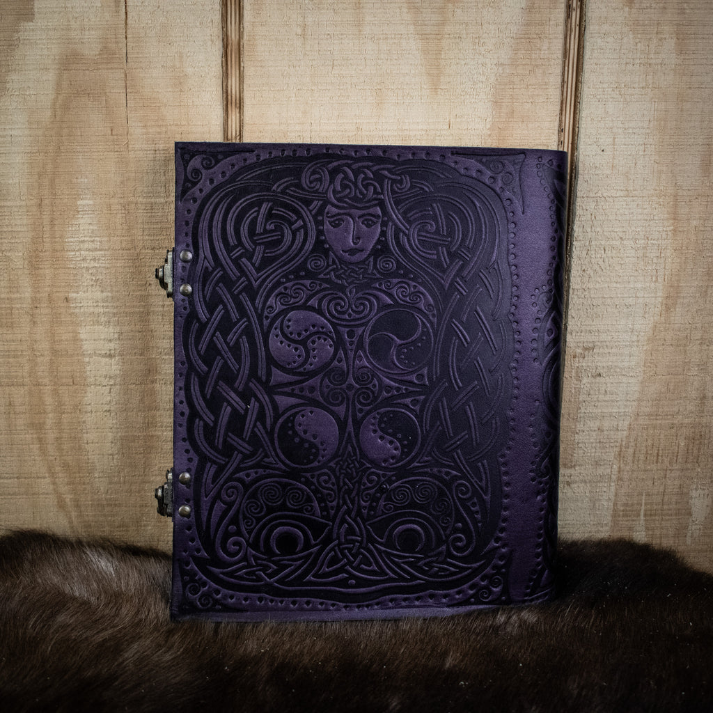 A leather sketchbook featuring an owl and woman