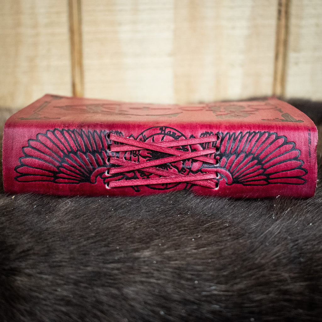 The spine of a red leather journal