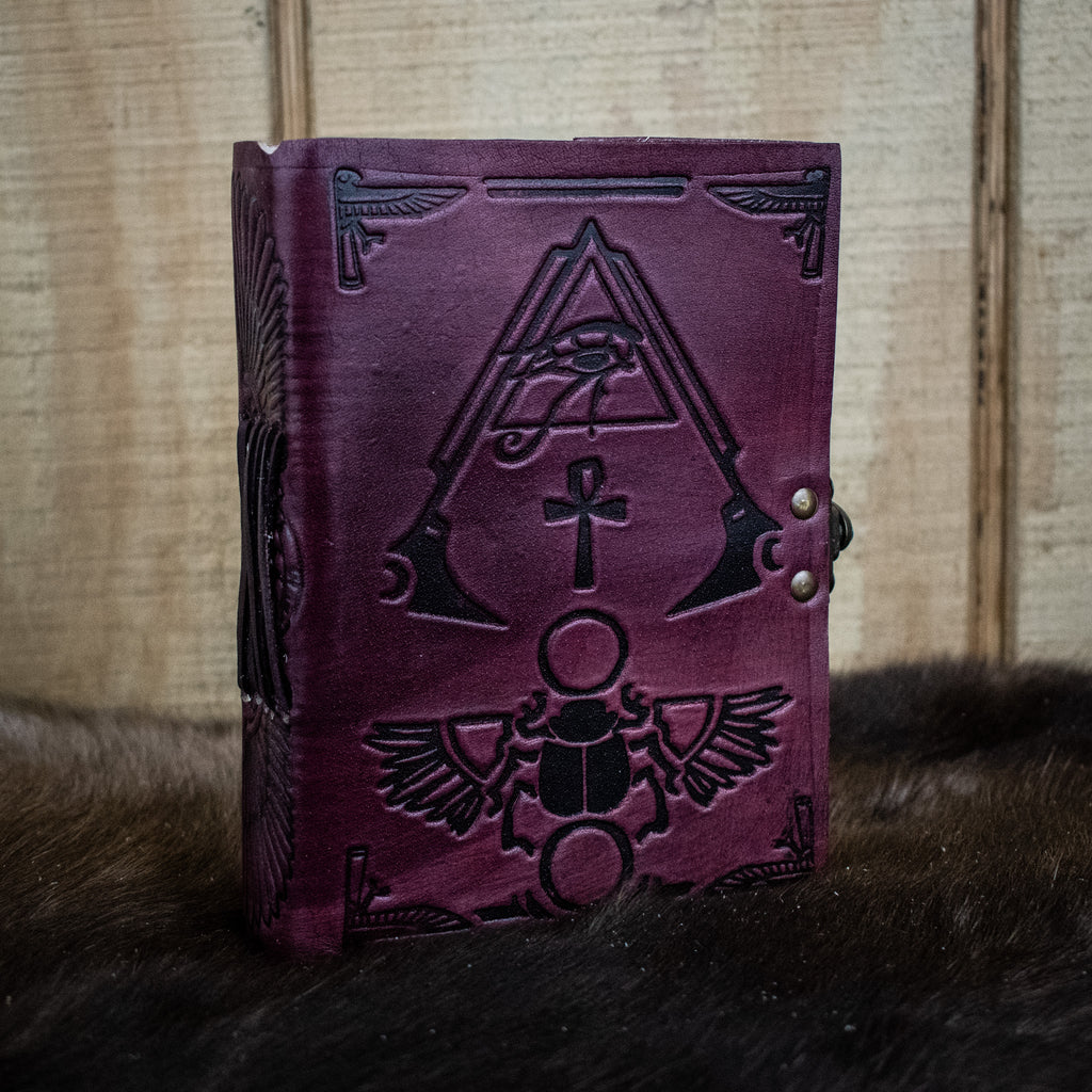 A purple leather journal featuring hieroglyphics 