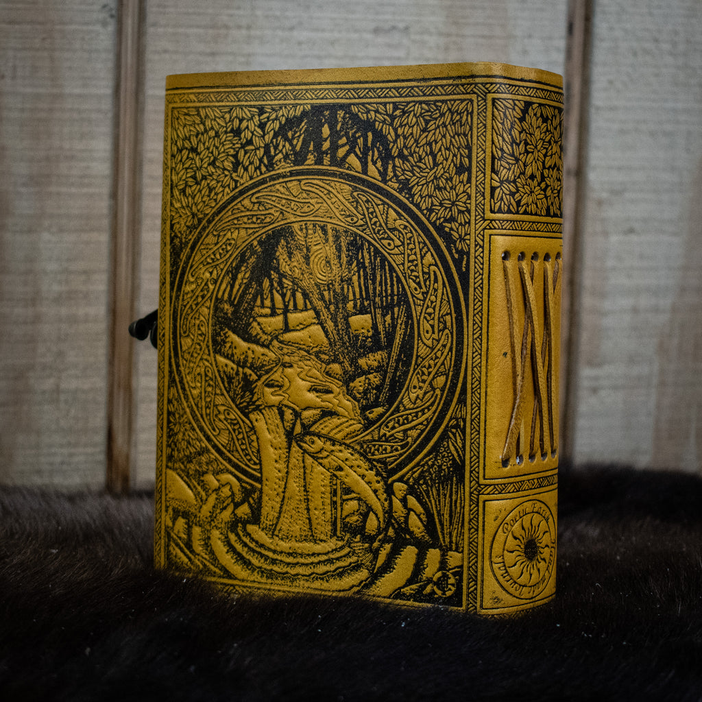 A yellow leather journal featuring the tree of life