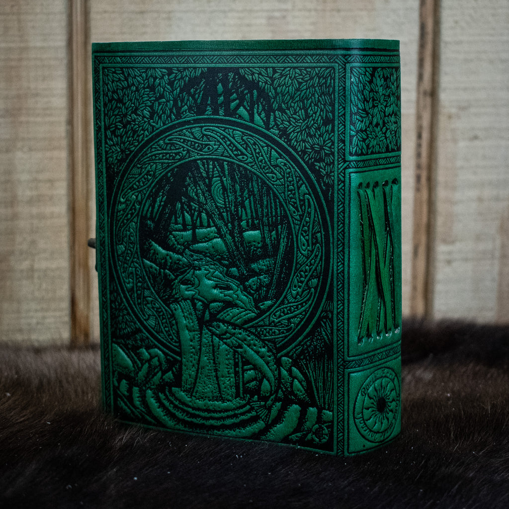 A green leather journal featuring the tree of life