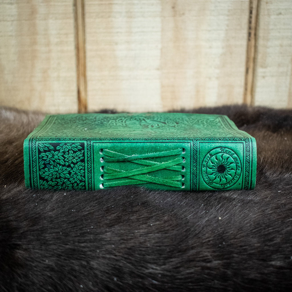 The spine of a green leather journal featuring the tree of life