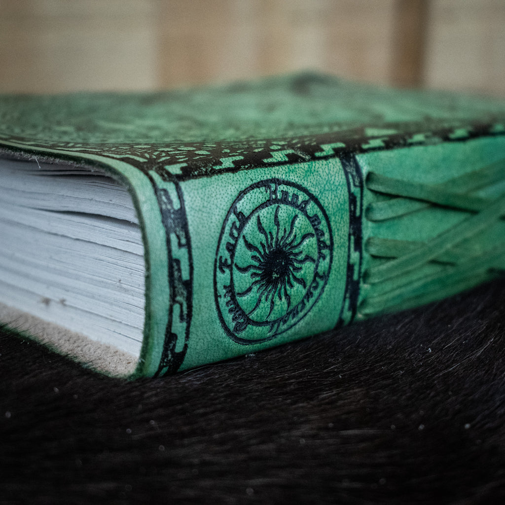 A green leather journal featuring mother earth