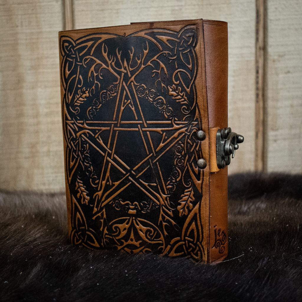 A brown leather journal featuring a pentacle 