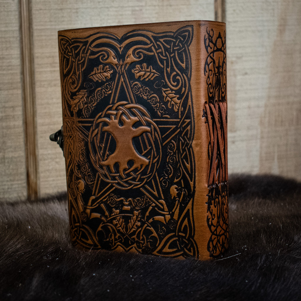 A brown leather journal featuring a pentacle 