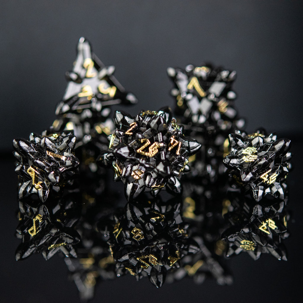Spiky black metal dice with gold numbers in a Nordic font