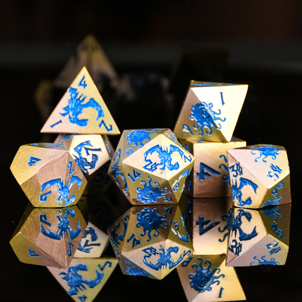 Set of polyhedral dice with blue dragon designs on a reflective surface