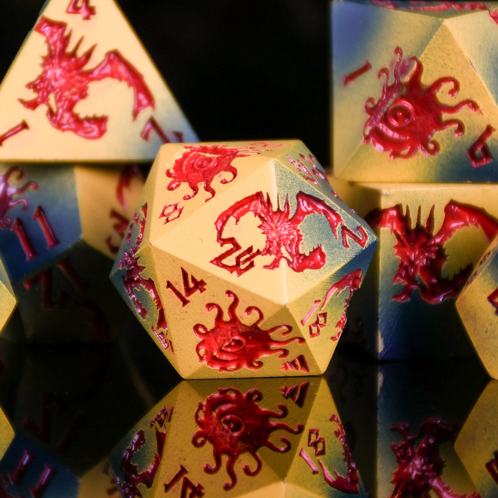 Close-up of polyhedral dice with red dragon designs on a reflective surface