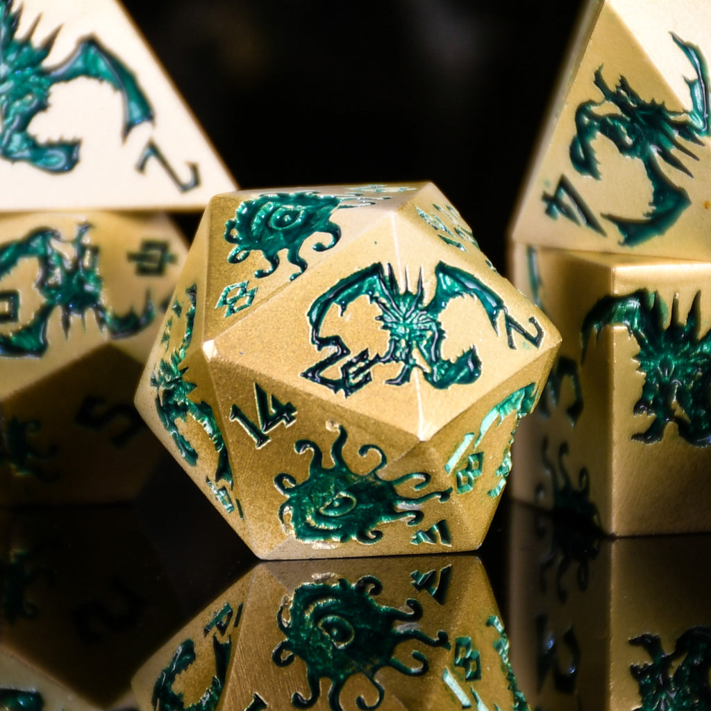 Gold polyhedral dice with green dragon design on a reflective surface