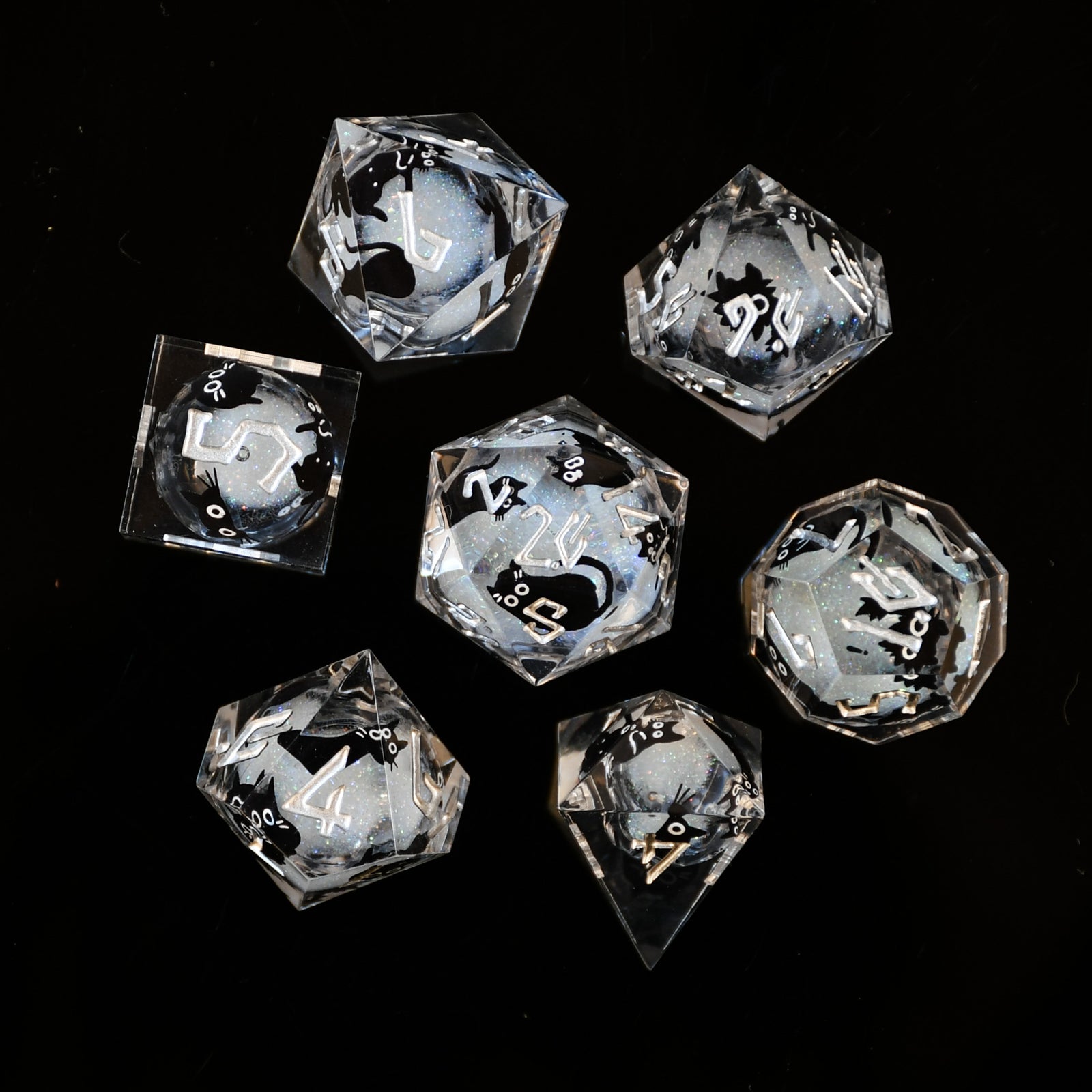 Set of crystal dice with engraved numbers on a black background