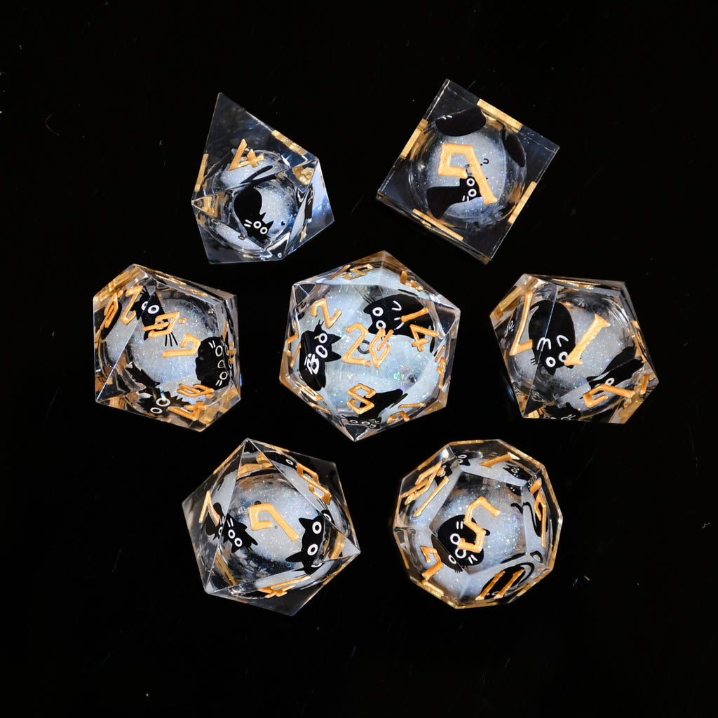 Set of clear dice with black and gold markings on a black background