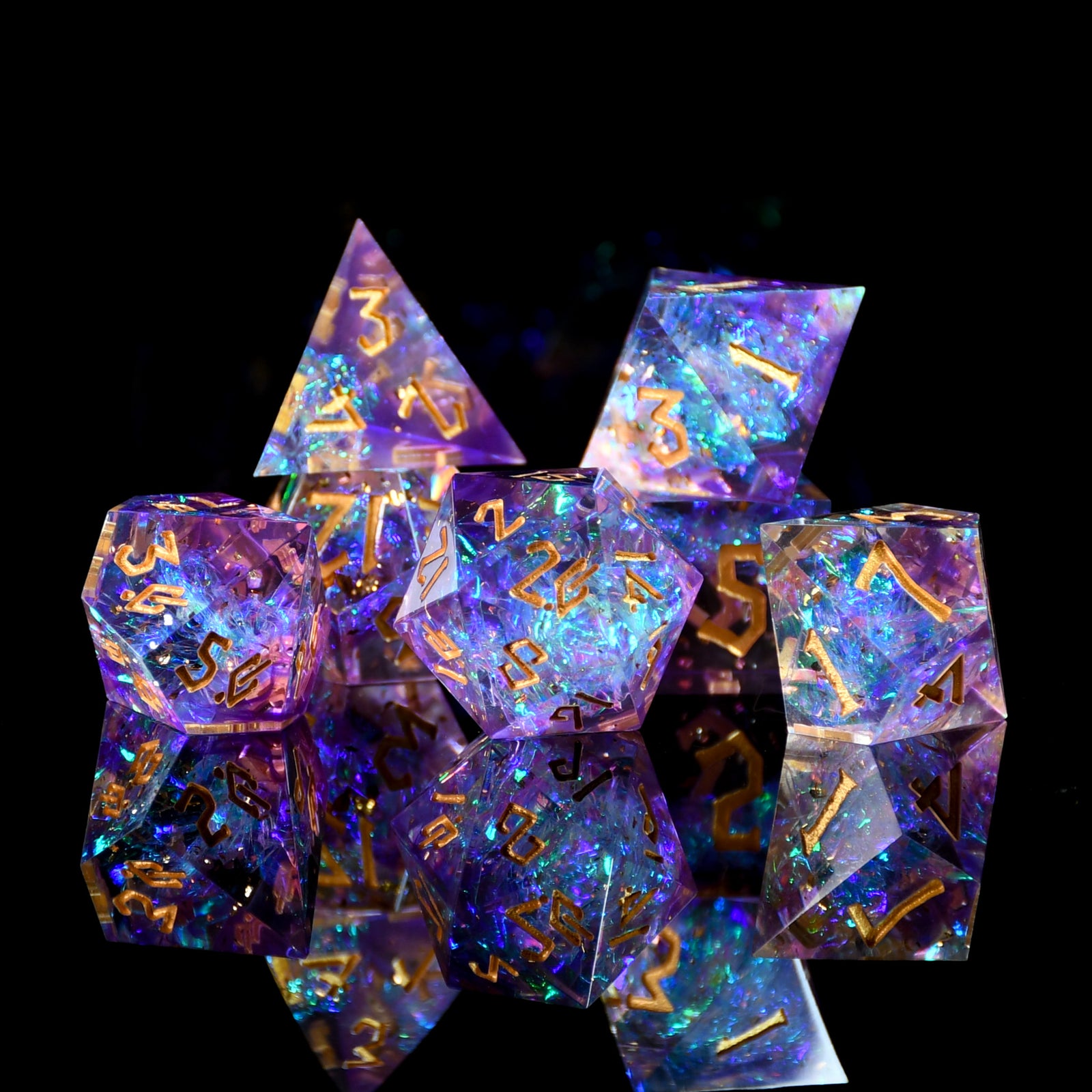 Set of colorful polyhedral dice with glowing effect on a black background