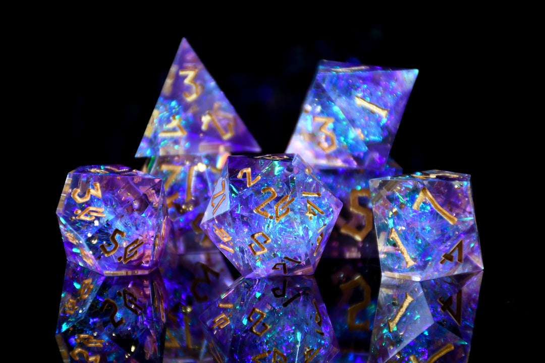Set of colorful polyhedral dice with numbers on a black background