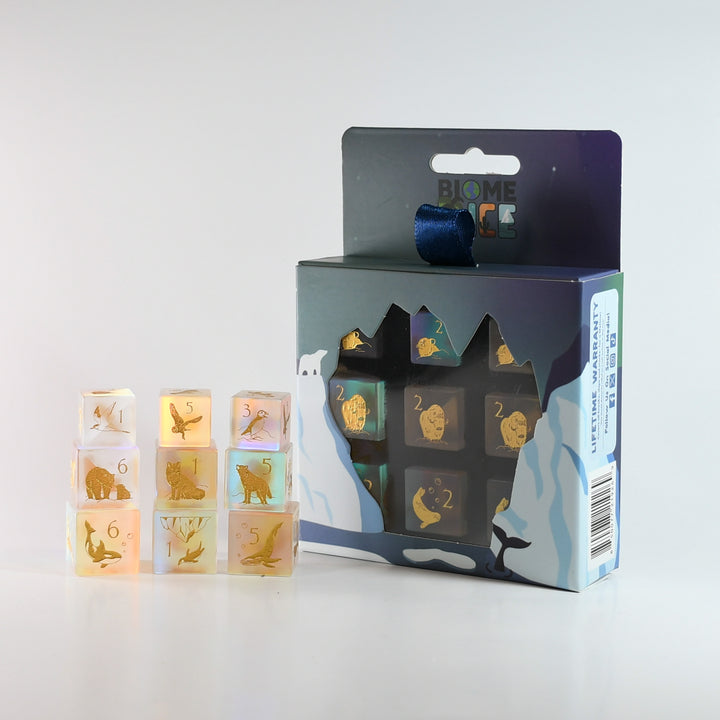 Set of transparent dice with animal illustrations and their corresponding numbers, displayed with packaging.
