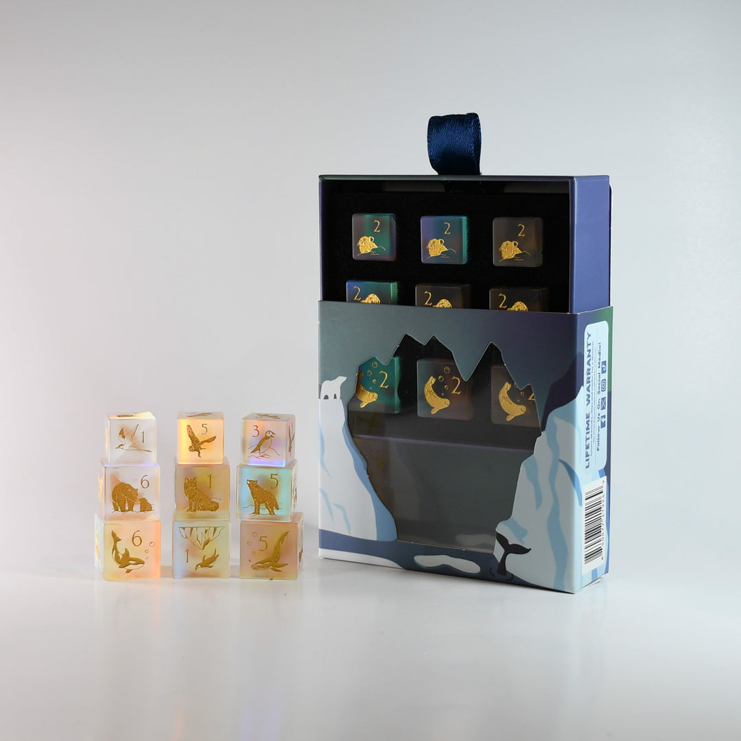 Set of animal-themed dice with packaging on a light gray background