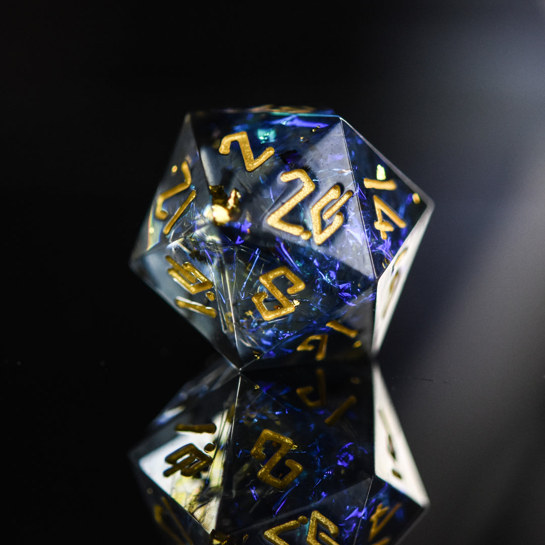 A set of sharp-edged resin dnd dice with blue and green metallic foil inside and gold numbering for tabletop gaming dungeons and dragons and board games