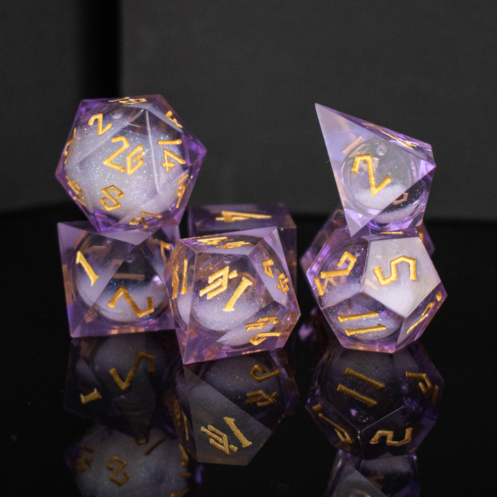 A set of purple resin dice with engraved numbers and a liquid core, displayed on a reflective surface.