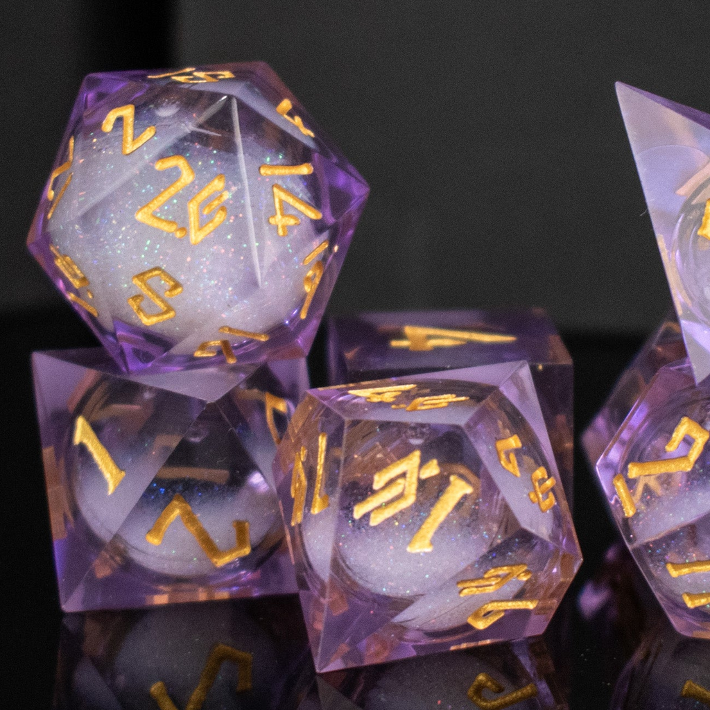 Set of purple polyhedral dice with gold numbers on a reflective surface.