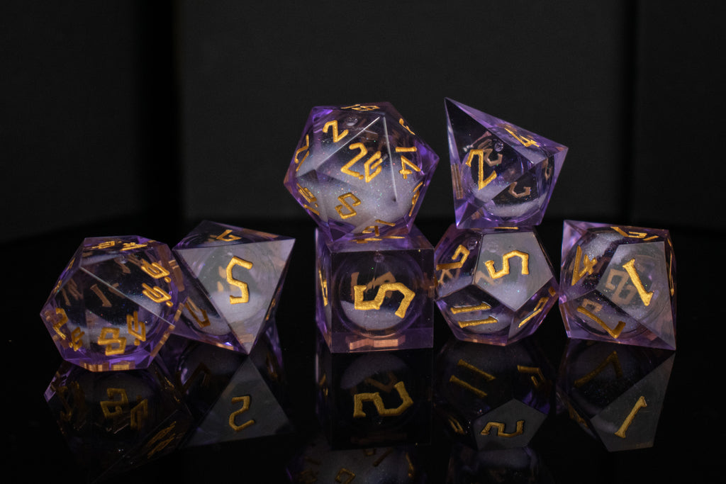 A set of purple resin dice with engraved numbers and a liquid core, displayed on a reflective surface.