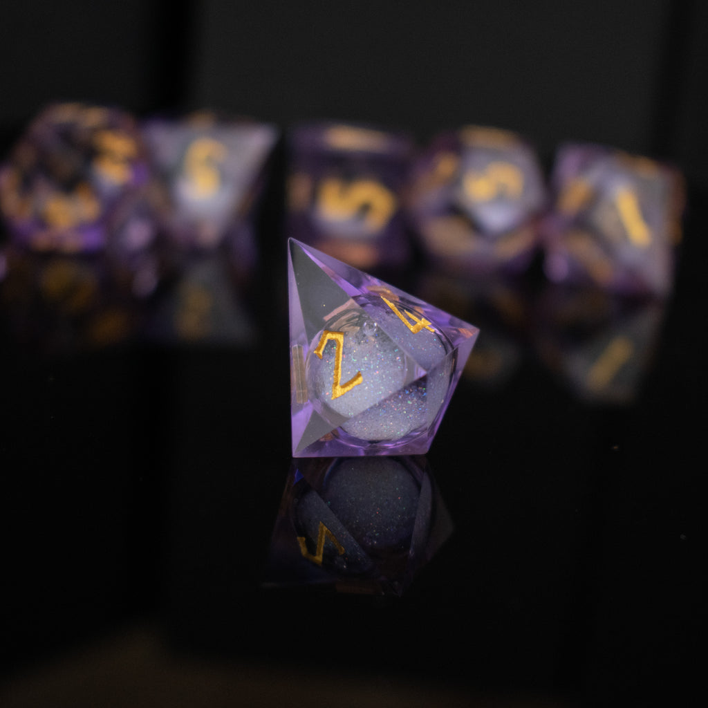 A set of purple resin dice with engraved numbers and a liquid core, displayed on a reflective surface.