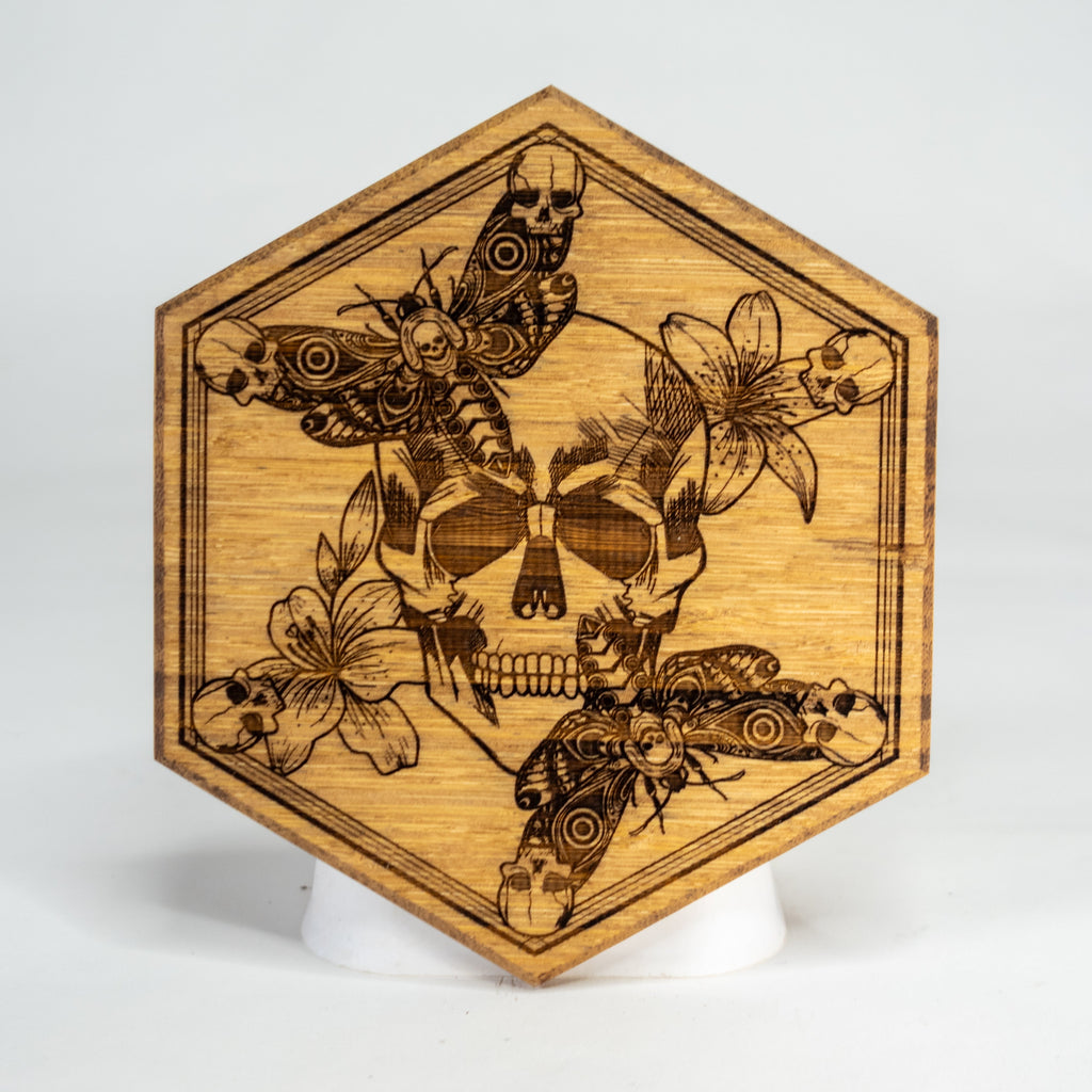 Hexagonal wooden coaster with laser-cut butterfly design on a white background