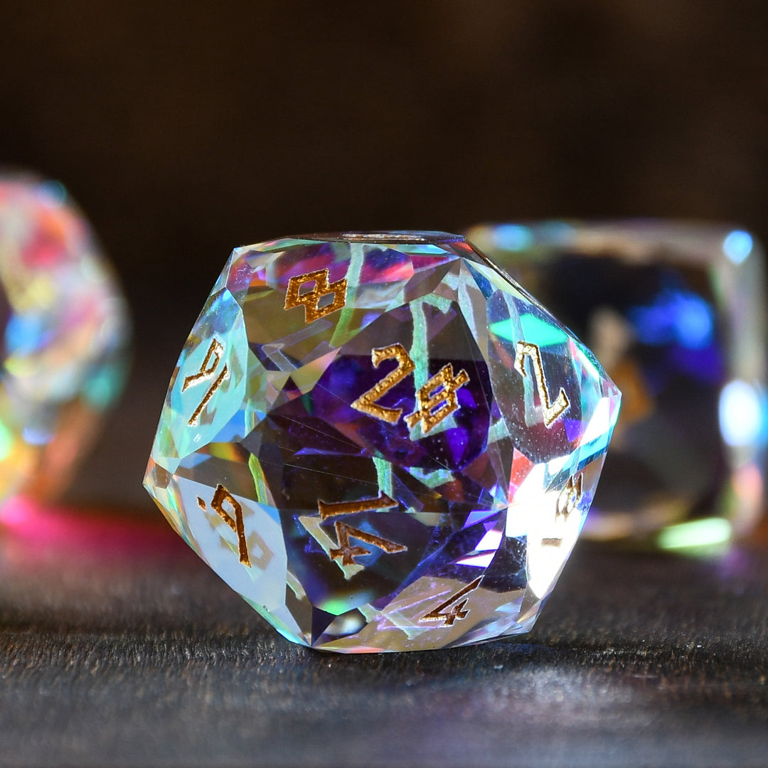 A close-up of a multifaceted, multicolored glass dice with engraved numbers, on a dark background.