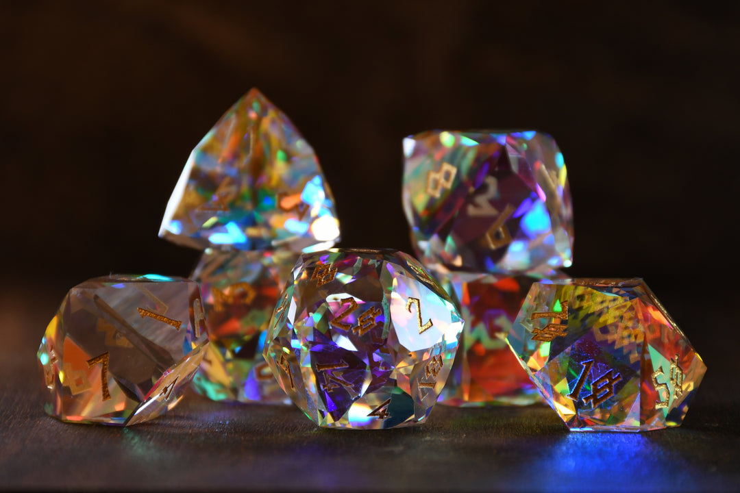 A close-up of a multifaceted, multicolored glass dice with engraved numbers, on a dark background.