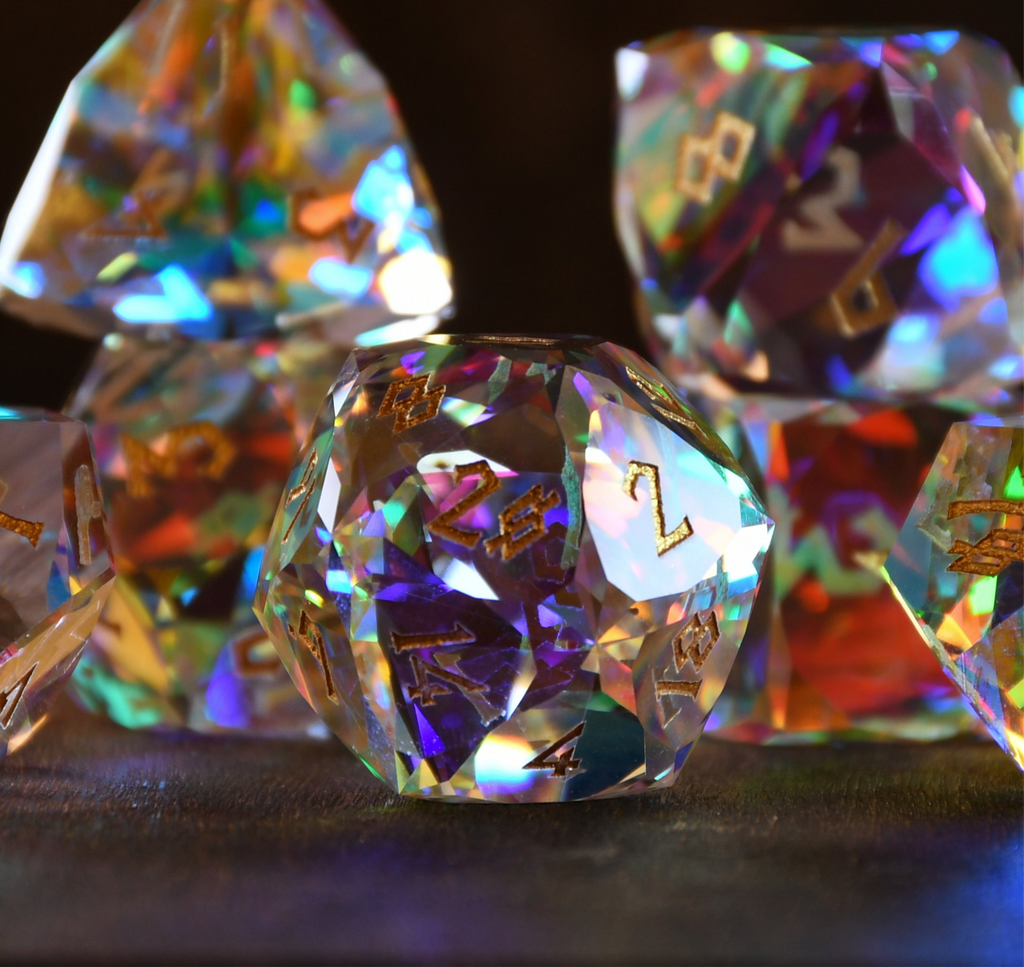 A close-up of a multifaceted, multicolored glass dice with engraved numbers, on a dark background.