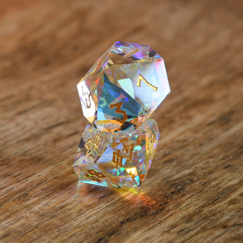 A close-up of a multifaceted, multicolored glass dice with engraved numbers, on a dark background.