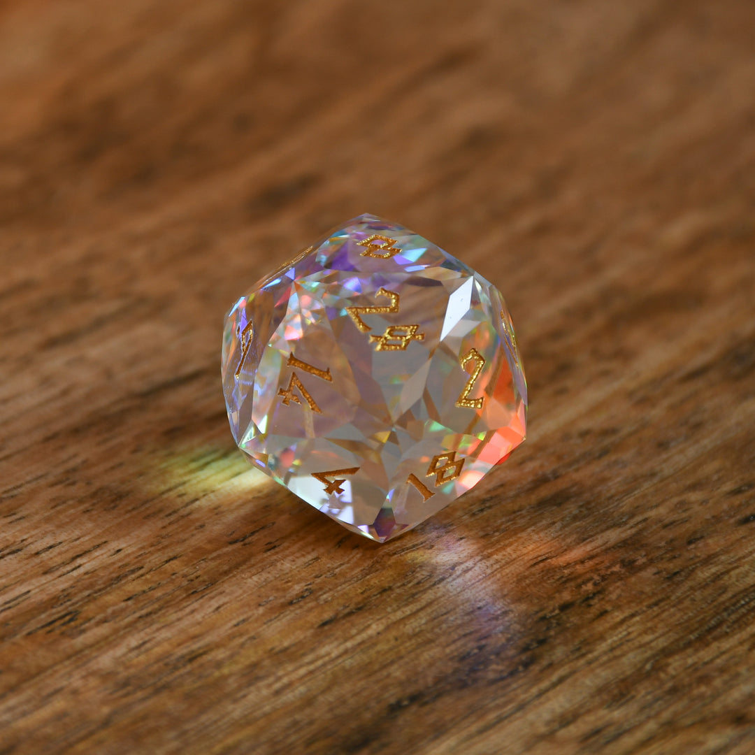 A close-up of a multifaceted, multicolored glass dice with engraved numbers, on a dark background.