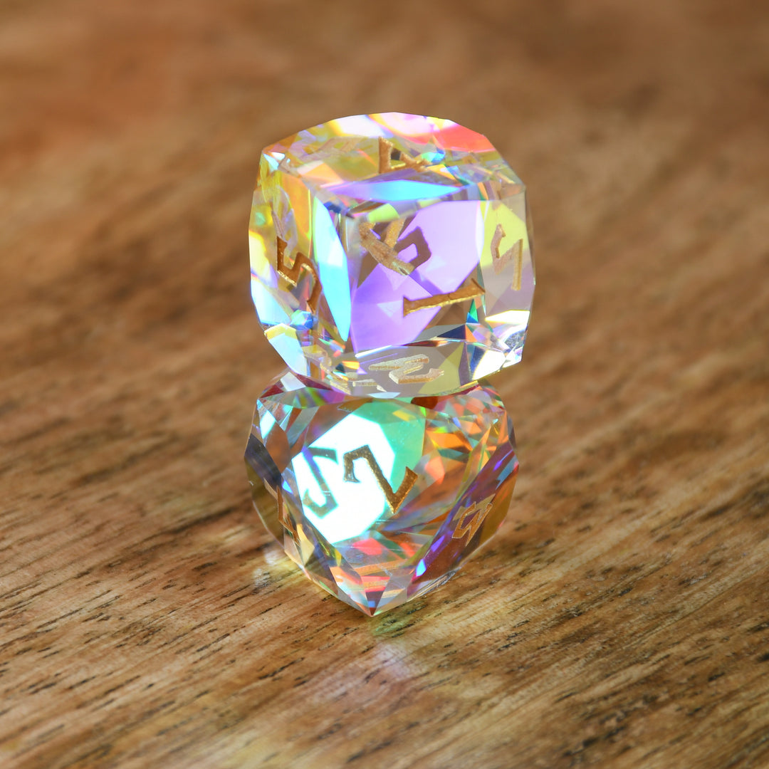 A close-up of a multifaceted, multicolored glass dice with engraved numbers, on a dark background.