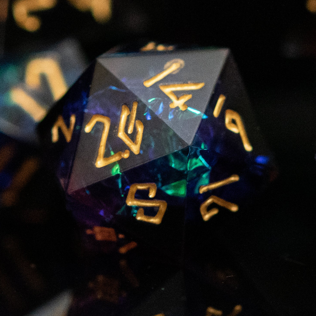a set of dark sharp edge resin polyhedral dnd dice with iridescent foil inside and gold numbering. 