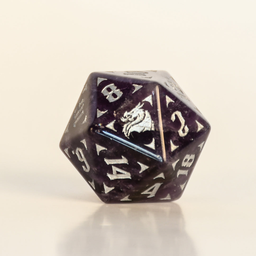 D20 polyhedral dice with a dragon emblem on a beige background