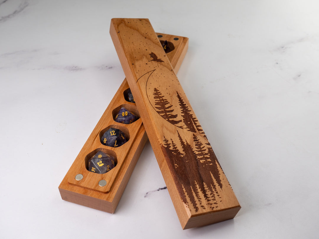 Wooden dice tray with engraved tree design on a white marble surface