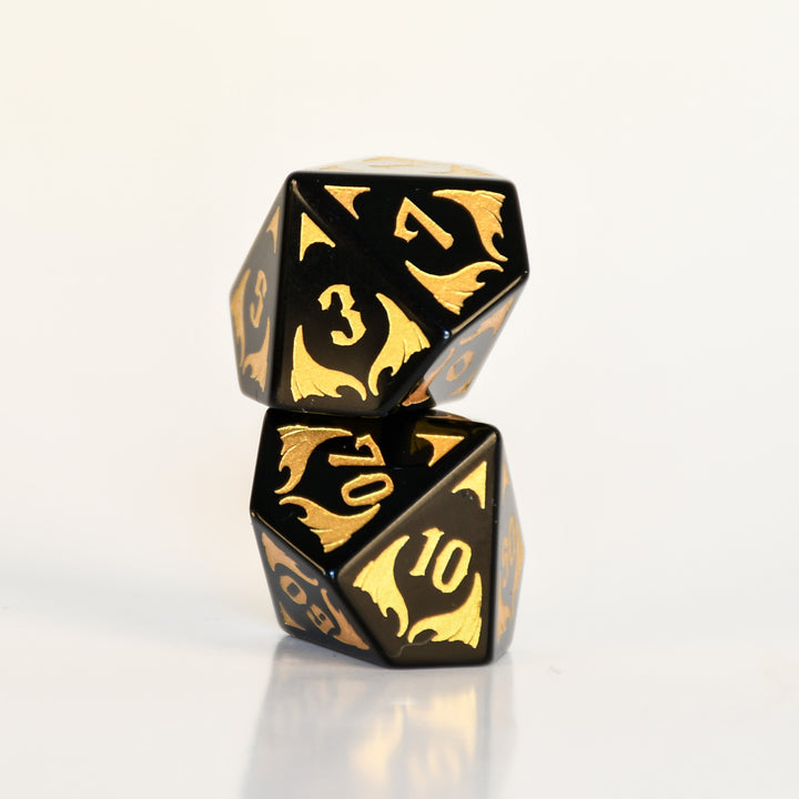 Black Obsidian Gemstone Polyhedral DnD Dice Set with gold numbers, dragon heads and wing adornments