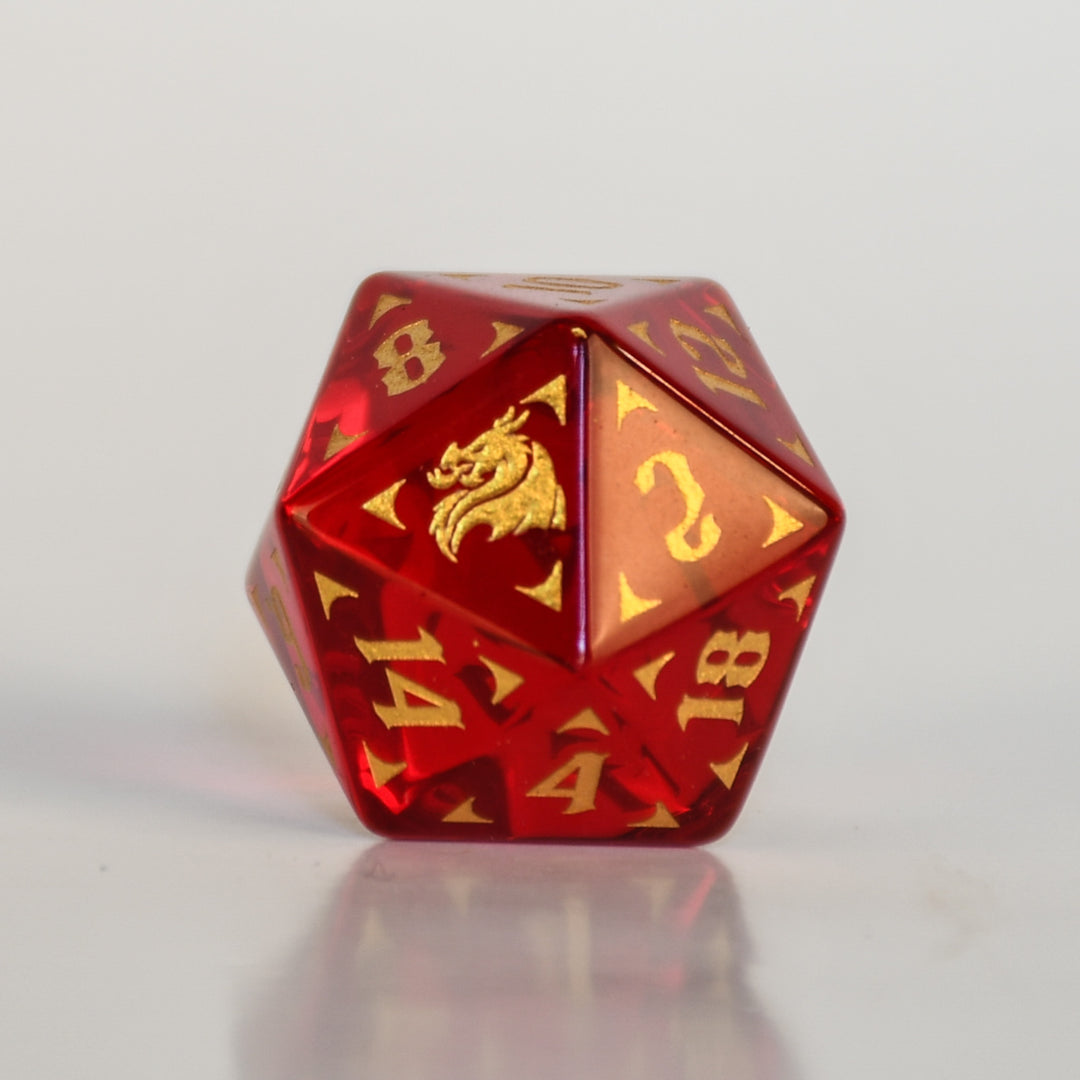 Set of red and gold polyhedral dice with dragon design on a dark background
