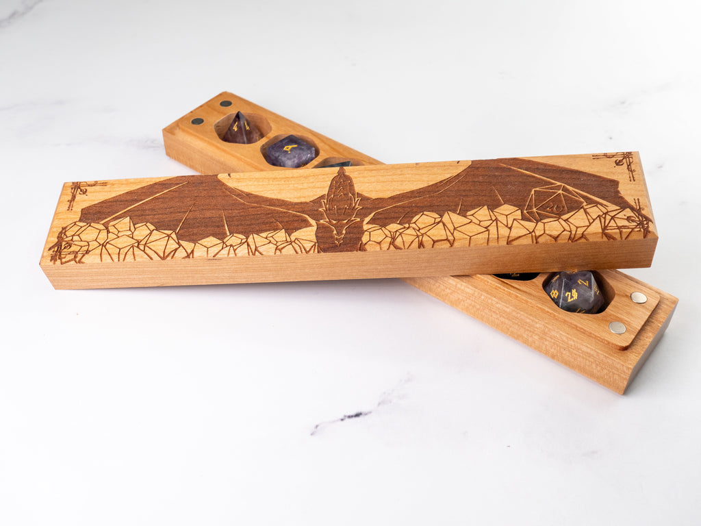 Wooden dice trays with laser-engraved designs on a white background