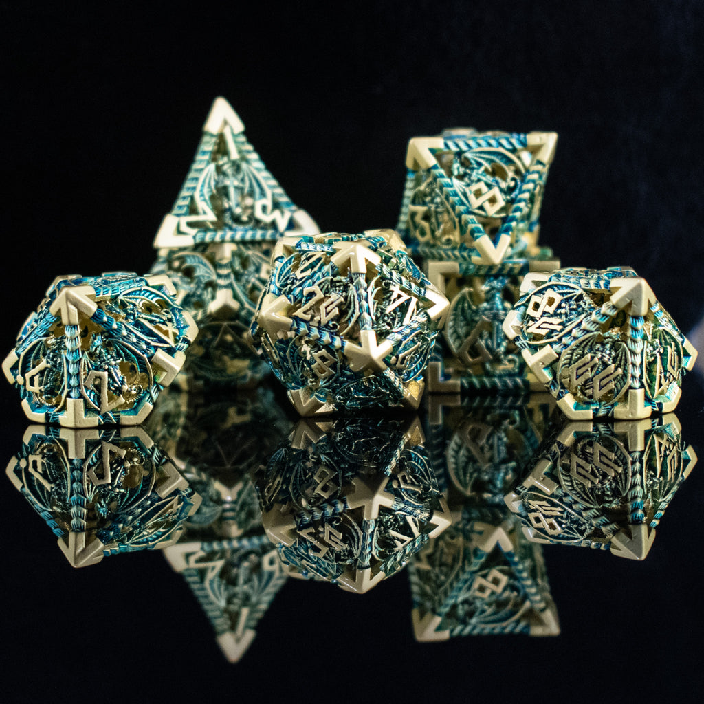A set of embossed metal hollow dice in blue and gold colors, displayed on a reflective surface.