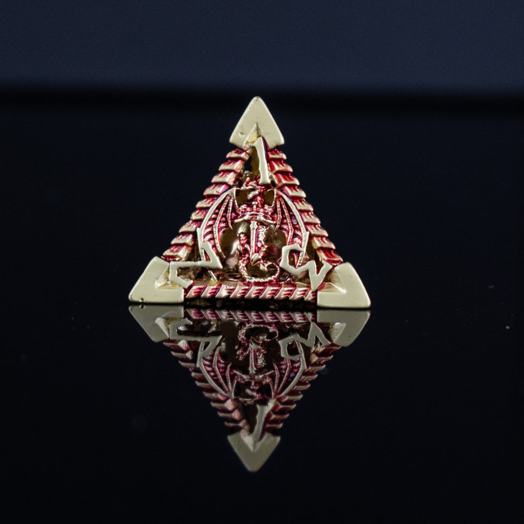 A set of embossed metal hollow dice in gold and red, with dragons displayed on a reflective surface.