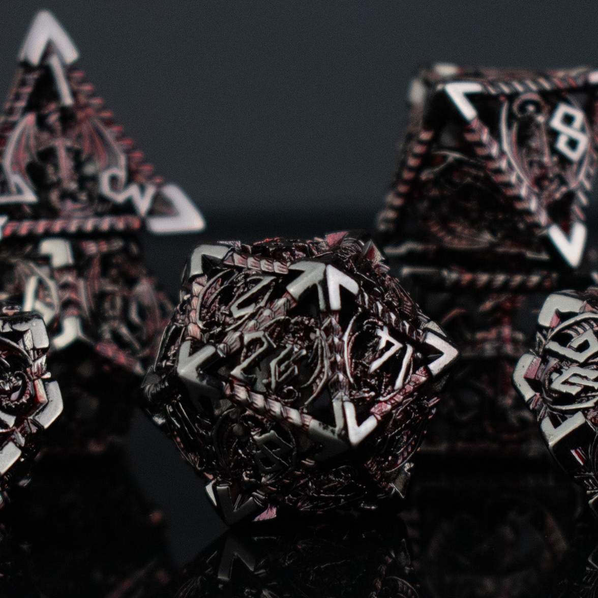 Close-up of intricately designed polyhedral hollow dice with a dark background