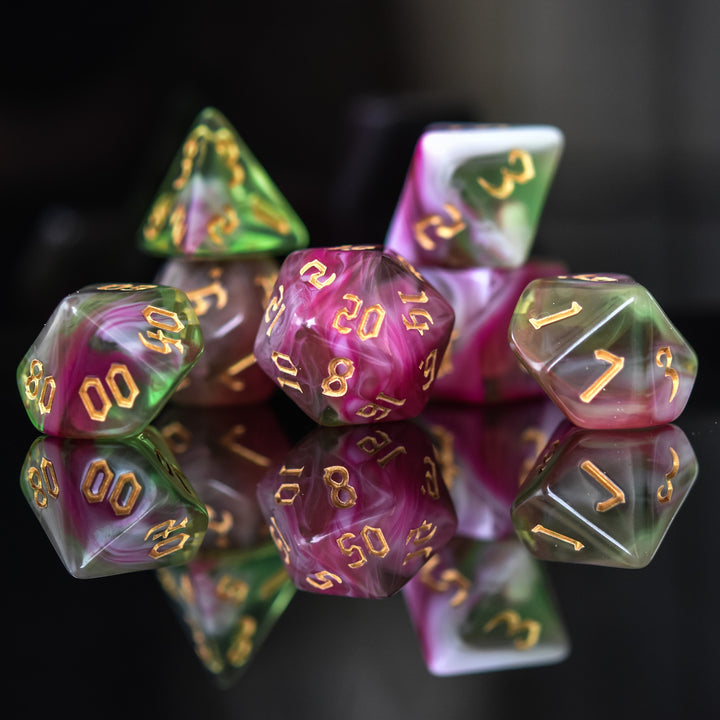 A set of multicolored acrylic dice with engraved numbers, including various shapes such as a d4, d6, d8, d10, d12, and d20, commonly used for RPGs.