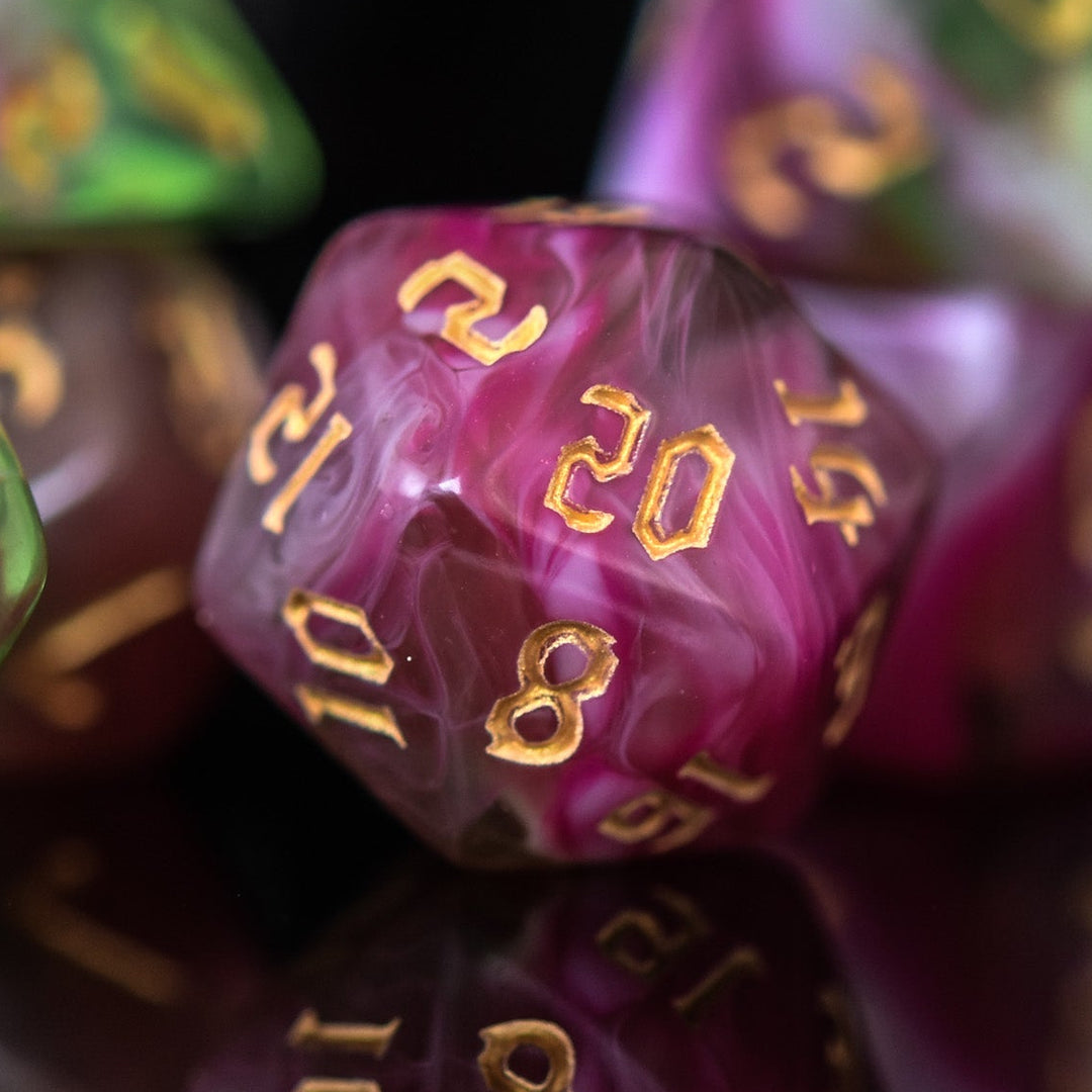 A set of multicolored acrylic dice with engraved numbers, including various shapes such as a d4, d6, d8, d10, d12, and d20, commonly used for RPGs.
