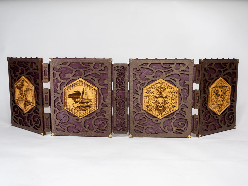 A selection of four compact dungeon master screens in various colors, each featuring a filigree pattern and brass fixtures, with magnetic acrylic panels for displaying maps and notes.